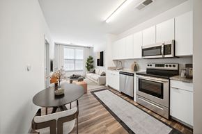 Richmond apartment for rent - A modern kitchen with a dining table and chairs at Circ Apartments, Virginia
