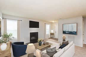 Greenville apartment for rent - A living room with a fireplace and a painting on the wall.