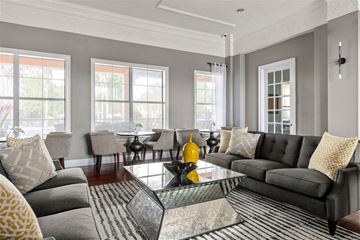 Clermont apartment for rent - A living room with grey couches and yellow pillows.