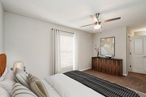 Raleigh apartment for rent - a bedroom with a large bed and a ceiling fan  at Lake Johnson Mews, Raleigh, 27606