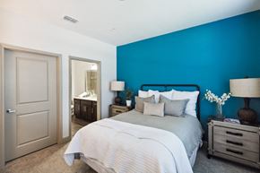 Jacksonville apartment for rent - Bedroom with Blue Wall and a Mirror at The Loree, Jacksonville, FL, 32256