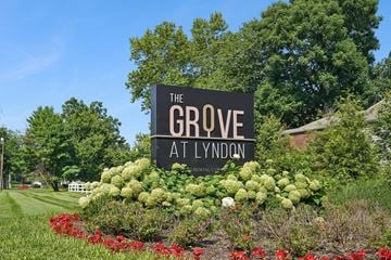Louisville apartment for rent - A sign that says "The Grove at Lyndon" is surrounded by flowers.