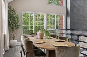 Louisville apartment for rent - A dining room with a table set for six with a view of trees outside.
