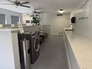 Phoenix apartment for rent - A laundry room with a washer and dryer, a fan, and a sink.