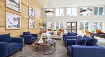 San Antonio apartment for rent - a living room with blue couches and chairs and a table