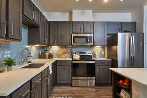 San Antonio apartment for rent - Upgraded Kitchen with Gray Cabinets, Stainless Steel Appliances, Kitchen Island, Backsplash at Addison Medical Center Apartments, San Antonio, 78229
