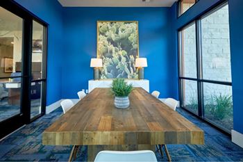 A wooden table with a plant on it and two lamps on either side.