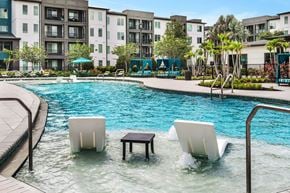 Tampa apartment for rent - A pool with a white float and a table in the middle of it.