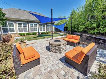Outdoor fire pit seating with orange cushions