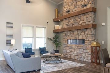 Greenville apartment for rent - a living room with a stone fireplace and a couch