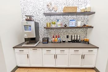 Coffee station with open shelving and white cabinets