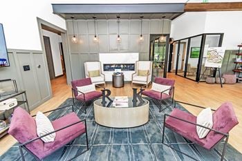 Clubhouse lounge with velvet seating and fireplace