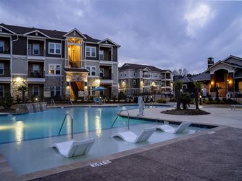Relaxing covered pool lounge featuring a fireplace & tv