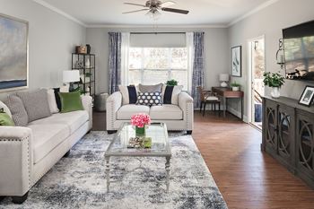 Furnished living room with dining nook and hardwood floors
