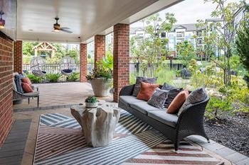 Poolside covered porch with soft seating and flat screen tv
