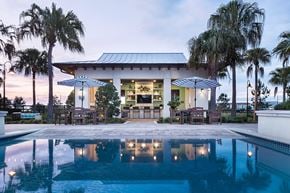 Apopka apartment for rent - Poolside cabana bar with outdoor seating and umbrellas at POINTE AT EAST SHORE Apartments, APOPKA, FL 32703