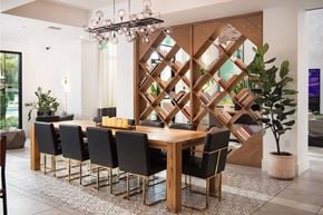 Apopka apartment for rent - Dining room with decorative wood partition and modern chandelier at POINTE AT EAST SHORE Apartments, APOPKA, FL