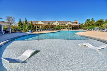 Resort pool with tanning ledge and builtin loungers
