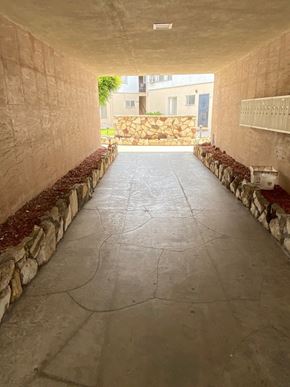 Los Angeles apartment for rent - A long, narrow hallway with stone walls and a stone floor.