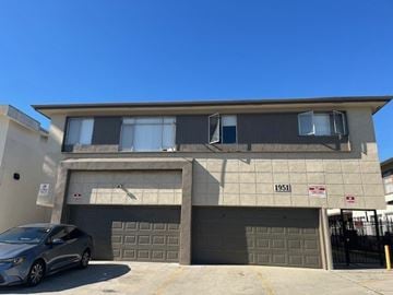 Los Angeles apartment for rent - A car is parked in front of a building with the number 1951 on it.