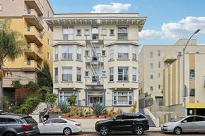 Los Angeles apartment for rent - A black car is parked in front of a white car.