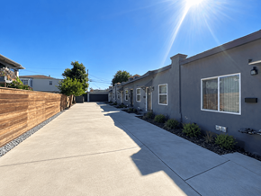 Los Angeles apartment for rent - A sunny day in a residential area with houses on both sides of a concrete path.