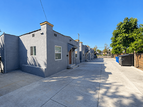 Los Angeles apartment for rent - A row of grey houses with a clear blue sky above.