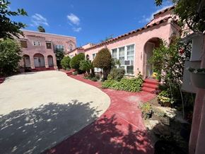 Los Angeles apartment for rent - A red brick pathway leads to a white door in a courtyard.