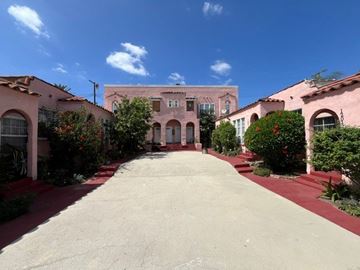 Los Angeles apartment for rent - A long driveway leads to a building with arched windows.