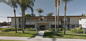 Mission Hills apartment for rent - A building with palm trees in front of it.