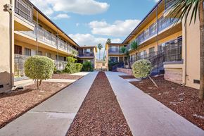 Los Angeles apartment for rent - A long concrete pathway leads between two rows of buildings.