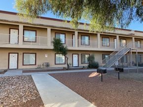 Bullhead City apartment for rent - Apartment complex with a tree in front and a staircase leading to the second floor.