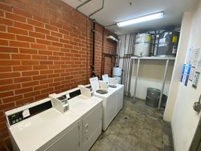 Los Angeles apartment for rent - A room with a brick wall and a white counter with a digital display.