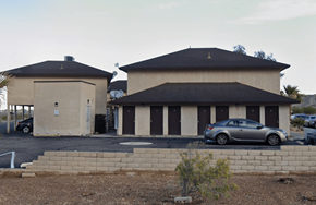 Bullhead City apartment for rent - A car is parked in front of a building with a black roof.