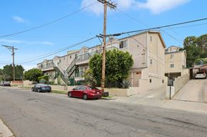 Los Angeles apartment for rent - A red car is parked on the side of a street.