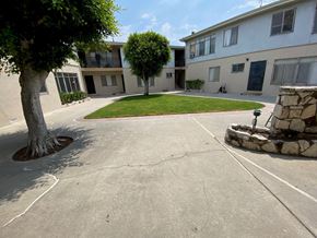 Los Angeles apartment for rent - A courtyard with a tree and a stone fireplace.