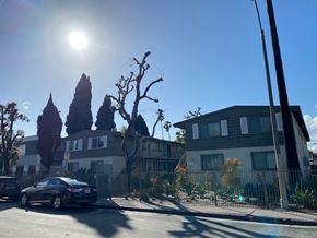Los Angeles apartment for rent - A black car is parked on the side of a street.