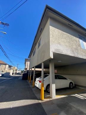 Los Angeles apartment for rent - A white car is parked in a parking garage.