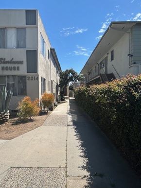 Los Angeles apartment for rent - A long, narrow sidewalk runs between two buildings with the name "Bankhouse" on the front.