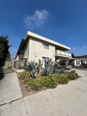 Los Angeles apartment for rent - A concrete building with a garden in front of it.