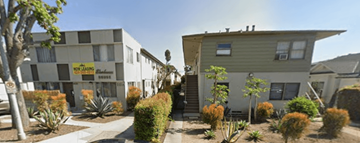 Los Angeles apartment for rent - A building with a sign that says "NO PARKING" is surrounded by plants and trees.