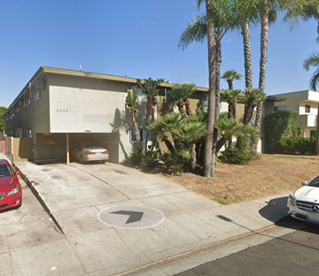 Los Angeles apartment for rent - A building with the number 2025 on it is surrounded by palm trees.