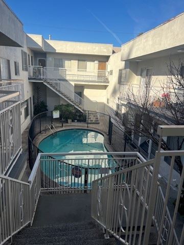 Los Angeles apartment for rent - A small pool is surrounded by a metal fence.