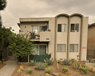 Los Angeles apartment for rent - A house with a balcony and a garden in front.