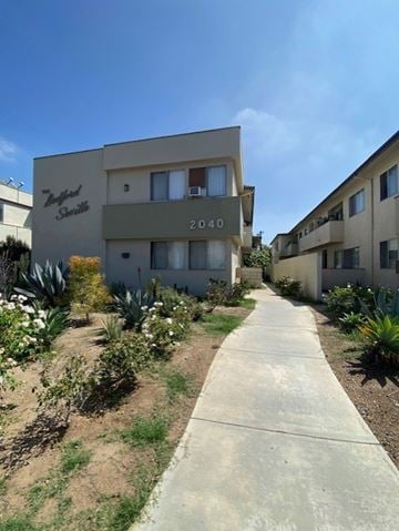 Los Angeles apartment for rent - A concrete pathway leads to a building with the number 2040 on it.