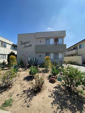Los Angeles apartment for rent - A building with the number 2040 on it is surrounded by plants.
