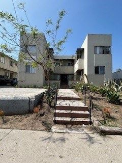 Los Angeles apartment for rent - A concrete building with a tree in front of it.