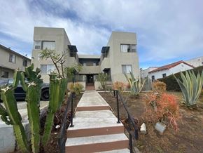 Los Angeles apartment for rent - A modern building with a concrete facade and a staircase leading to the entrance.