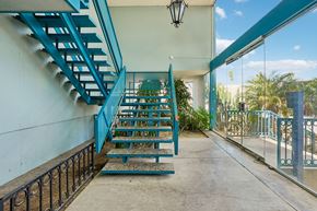 Los Angeles apartment for rent - A blue staircase with a black railing.