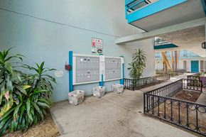 Los Angeles apartment for rent - A blue wall with a white electrical panel and a sign on it.